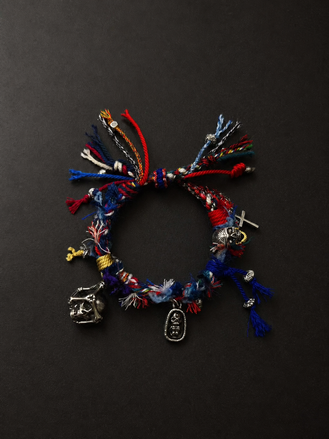 Deep red and indigo braided statement bracelet with layered multicolour details